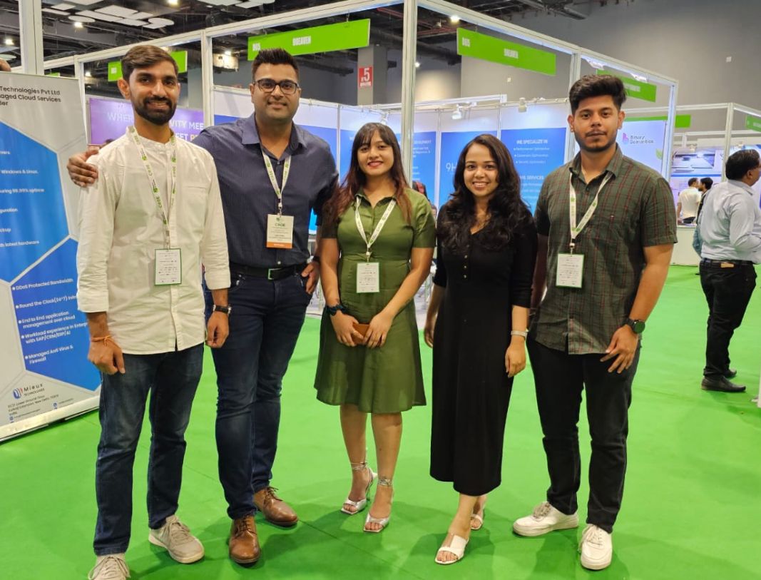 Sachin Upadhyay at a tech conference booth with fellow attendees